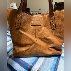 This is a beautiful tan Nicole Miller purse.